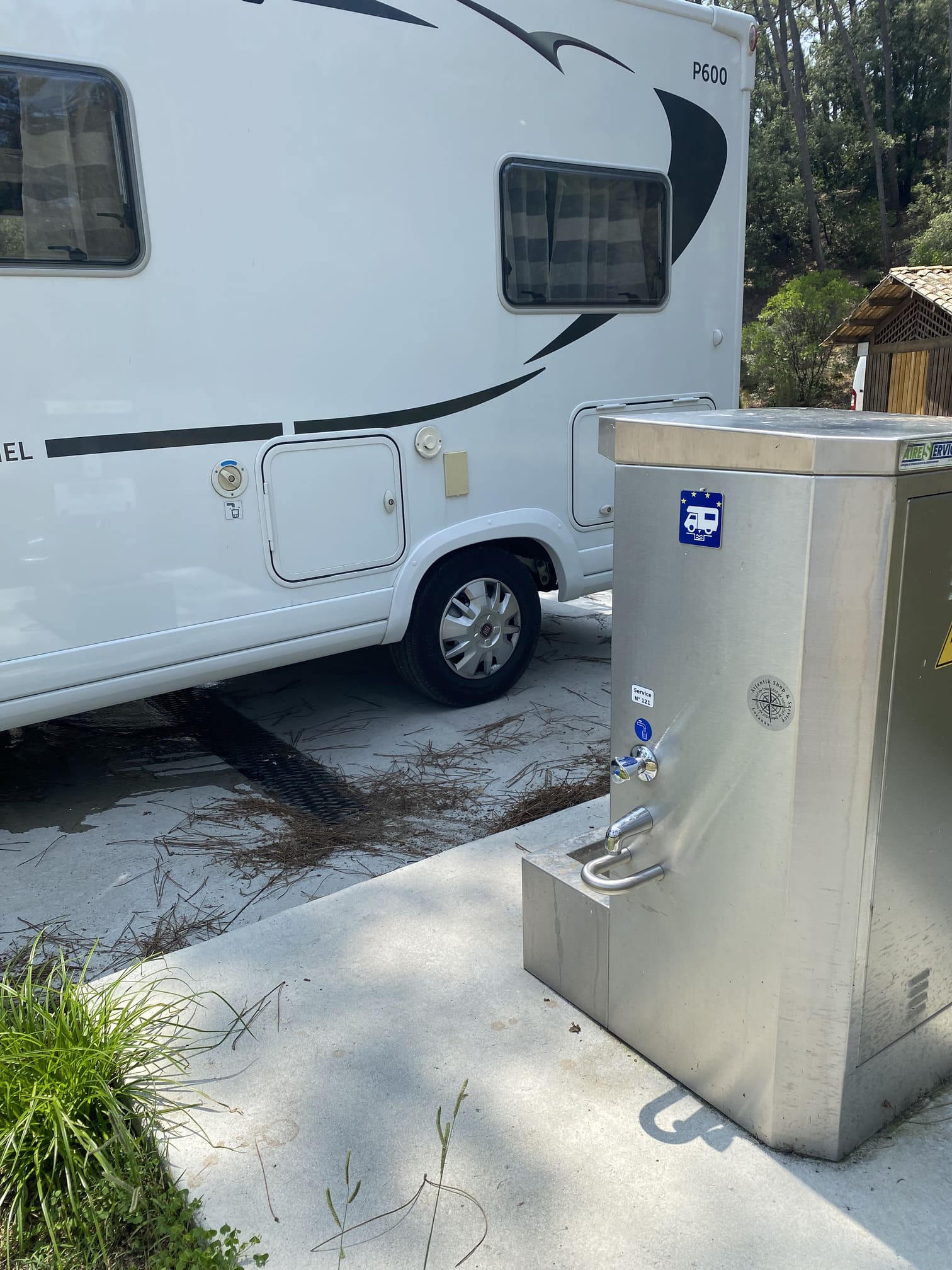 Camping car parked next to a dump station.