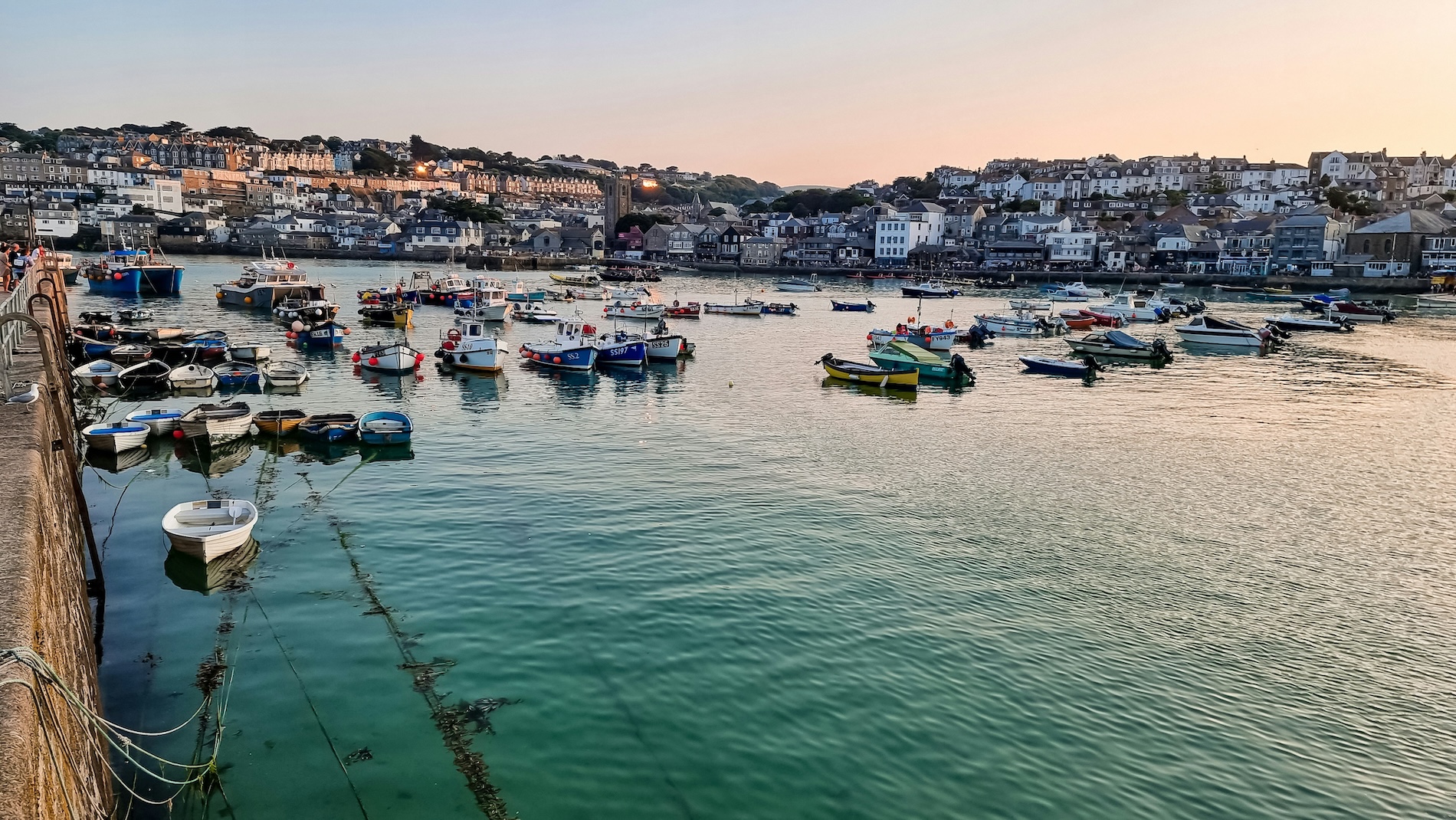 St Ives, Cornwall, United Kingdom: a charming seaside town with golden sandy beaches, turquoise waters, picturesque harbour views and colourful coastal cottages.